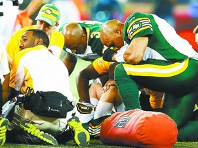Eskimos quarterback Kerry Joseph, right, kneels over back-up quarterback Matt Nichols after he was injured against the Toronto Argonauts during the second half of the East Semifinal Sunday.
Mark Blinch/Reuters