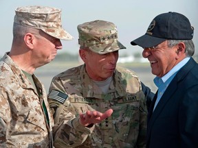 USMC Lt. General John Allen (L) and U.S. Army General David Petraeus (C) greet U.S. Secretary of Defense Leon Panetta after Panetta's arrival in Kabul, Afghanistan in this July  9, 2011 file photograph. (REUTERS/Paul Richards/Files )