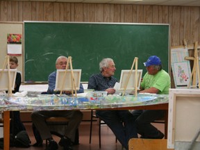 Simon Arseneau/Fairview Post 
Glen Hoover (far right) teaching the art of oil painting to amateur artists at the Fairview Fine Arts Centre on Saturday.