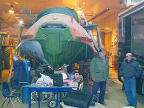 Chris Eakin/Fairview Post 
The fuselage of the Canso looms like some prehistoric dinosaur in Brian Wilson’s shop a few miles southwest of Fairview where the Annual General Meeting of the Fairview Aircraft Restoration Society took place Nov. 8. Pius Doll and Don Wieben stand near the aircraft.