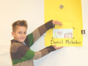 Daniil Melnikov, a Grade 3 student in Greenley's class at Kincardine's St. Anthony's School, shows off his envelope design that had been chosen for the Kincardine Community Healthcare Foundation holiday campaign during a nail-biting unveiling of the winning creation on Nov. 8, 2012. (SARAH SUTTER/KINCARDINE NEWS)