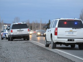 Greater Sudbury Police vehicles line the side of road on MR 80 in the McCrea Heights area Tuesday afternoon. Cops were searching for several hours for a 14-year-old who allegedly broke into a house on the highway.