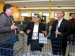Kingston and the Islands MP Ted Hsu (centre) talks with VOCEC worker Danny Dionne (left) as Providence Care president and CEO Dale Kenney looks on.
Ian MacAlpine The Whig-Standard