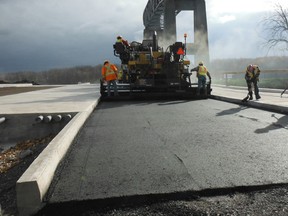 Crews pour asphalt for the southbound lanes of the canal span, the first of two bridges connecting the city to Cornwall Island. Construction on the major project is ongoing, along with discussions of where the port of entry will be located when the old structure comes down.
Submitted photo