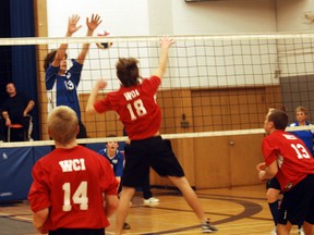 Alex Borbieri of Ingersoll blocks Woodstock Collegiate's Justin Elms (No. 18) spike in the fifth set of Tuesday afternoon's southeast junior boys volleyball finals. Ingersoll won three sets to two, but both teams will compete at WOSSAA.