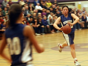 Huron Park Huskies point guard Kristina Chung (centre) passes to Kim Shepard (left) in the fourth quarter of the southeast junior girls basketball finals against the East Elgin Eagles. The Eagles won in the final seconds 40-38.