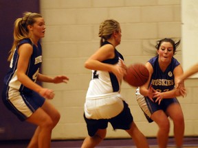 Huron Park's Hilary Bender (right) looks to steal the ball from a East Elgin Eagles player in the southeast senior girls finals Tuesday night while Chantal Millar (left) boxes her out. East Elgin would win the game 46-33 to end Huron Park's season.