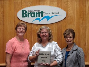 Members of the Paris Pool committee Dora Kuilboer, left, Thecla Ross and Zedo Henny show off one of the bricks available for purchase to support the fundraising for the new public pool in Lions Park. A donation of $200 will get the donor an inscribed brick place on the pathway from the pool to the sprinkler pad. SUBMITTED PHOTO