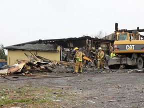 Firefighters put out the final hot spots after a fire destroyed a former garage on Hwy. 38, north of Kingston on Nov. 19.
Danielle VandenBrink/The Whig-Standard