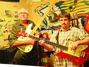 Roger Eccleston and Chris Morris each hold a bass played by the late Joe Chithalen at Joe’s Music Instrument Lending Library. On Monday, Nov. 17 at the Mansion, A Joe Show will take place, honouring Chithalen.     Contributed photo