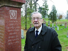 Bill Fitsell reads the headstone of Capt. James T. Sutherland located in the Cataraqui Cemetery. Of special interest are the engraved hockey sticks at the top. Fitsell has written the book Captain James T. Sutherland, The Grand Old Man of Hockey and the original Hockey Hall of Fame, which will be launched Monday, Nov. 19 at Kingston City Hall.     Rob Mooy, Napanee Guide