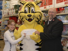 RICK OWEN • Northern News
Evan Schonfeldt, who organized a penny drive for the Kirkland Lake Salvation Army, left, Giant Tiger, who's customers made donations, present Kirkland lake Salvation Army Capt. George Hastings with a cheque for $1,589 for the food bank.