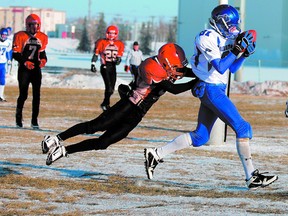 Ardrossan slotback Brett Enns hauls in a touchdown pass beyond the reach of diving Sabre defender Levi Stewart during the Bisons’ 27-14 win over Sexsmith on Saturday in Grande Prairie. Photo by Shane Jones/Sherwood Park News/QMI Agency