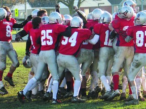 Members of the La Citadelle Patriotes celebrate their championship, after a 23-0 win against Casselman on Thursday.