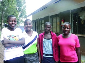 The four students from the Birere Secondary School in Kasana, Uganda stand in front of the “Rotary Canada” hostel.  A fundraiser is being held this Saturday at Sherwood Park’s 55+ Club to support education at the Ugandan school. Photo Supplied