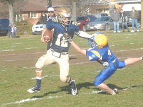 Delhi quarterback Kyle VanWynsberghe stiff-arms a McKinnon Park defender and escapes for a big gainer during the league semifinal Thursday at Delhi District Secondary School. Delhi won the game 28-7 and will take on the Waterford Wolves in next week's Haldimand Norfolk Bowl. (JEFF DERTINGER Simcoe Reformer)