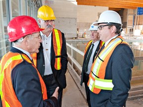 BRIAN THOMPSON, The Expositor

Ontario Minister of Infrastructure Bob Chiarelli (left) talks with Brant MPP Dave Levac, Brant Mayor Ron Eddy and Brantford Mayor Chris Friel on Thursday during a tour to see the construction of the next phase of the Wayne Gretzky Sports Centre.
