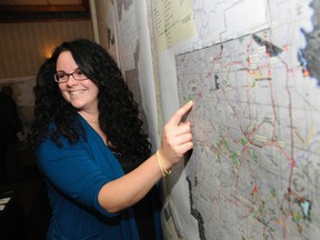 Sarah Martin, planning forester for Weyerhaeuser, points a map outlining the pulp company’s harvest plans in this 2012 meeting. Canfor Corporation is partnering with Weyerhaeuser Canada, to hold an open house meeting on Monday, concerning their vegetation management programs. Graeme Bruce/Daily Herald-Tribune