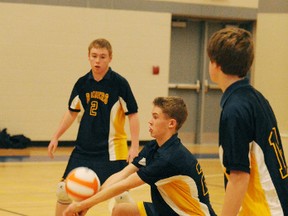 Jake Vanbesien of the Delhi Raiders junior boys volleyball team bumps the ball during Ontario regional playoffs held at Simcoe Composite School on Thursday. Watching is teammate Brant Paulmert. Delhi was eliminated early. (DANIEL R. PEARCE Simcoe Reformer)