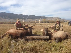 Verona’s Mike Smith, right, a goalie with the NHL’s Phoenix Coyotes, and his father, Ron, stand over the bull elks they shot during a hunting trip in Leadore, Idaho.