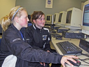 Owen Sound IceHawks peewee A's left-winger Hillary Holyome (left) and centre Sasha Morano (right) examine the ImPACT baseline testing which is part of a concussion management program that the Owen Sound Minor Hockey Group and Owen Sound Girls Hockey are taking part in with the assistance of Bayshore Physical Therapy.