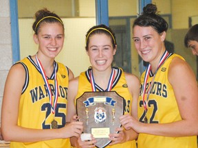 MIKE SAVAGE The Beacon Herald
St. Michael Warriors’ co-captains, from left, Becky Dewetering, Laura Vere and Bridget O’Reilly, hold the WOSSAA ‘AA’ plaque following the Warriors’ 67-32 win over Tillsonburg Gemini in the championship game Thursday in St. Thomas.