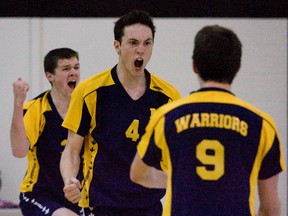 St. Michael Warriors L to R Tyler Kocher, Marcus Henke and Ethan McCarroll celebrate the penultimate point of the final game of their TVRAA "AA" volleyball championship match against the Westminster Wildcats in London, Ontario on Thursday, November 15, 2012. The Stratford team scored the next point to win the title on Wildcat turf,, three games to one.
DEREK RUTTAN/ The London Free Press