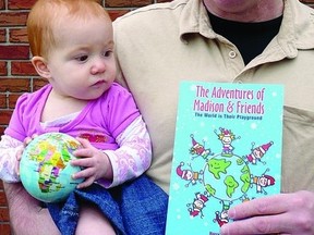 Local author Harry Jordan reads his new book The Adventures of Madison and Friends to his granddaughter.      Contributed photo