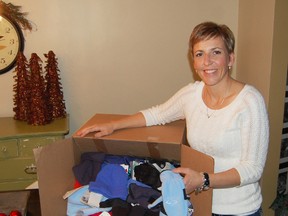 Tammy Kyle, president of the Tillsonburg Kinette Club, stands next to a box of about 70 brand new hats and mitts recently purchased by the club, that will be given to the Salvation Army for their Kids and Coats campaign this winter. The Kinette Club will be collecting donations of new hats and mitts for children and teens during the Santa Claus parade this Saturday, November 17, 2012. 

KRISTINE JEAN/TILLSONBURG NEWS/QMI AGENCY