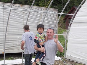 Evans is pictured with a young local boy from one of the villages in Japan where his GlobalMedic team built shelters in October.
