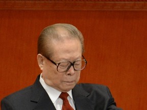 Former Chinese president Jiang Zemin checks his watch during the opening of the 18th Communist Party Congress last week at the Great Hall of the People in Beijing on November 8, 2012. The warm welcome received by Jiang, who believes China must retake Taiwan, suggests that Jiang's fellow hardliners may be gaining control again.