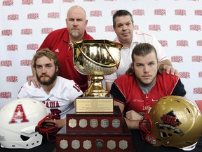 Jeff Cummins of the Acadia Axemen, Glen Constantin of the Laval Rouge et Or, Kyle Graves of Acadia and Arnaud Gascon Nadon of Laval, on Thursday, November 15, 2012 in Quebec City. (QMI Agency/SIMON CLARK)