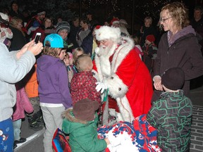 Santa greets his fans during the Downtown Development Board's annual city hall tree lighting ceremony Friday evening.