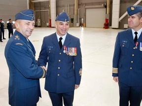 Lt. Gen. Yvan Blondin, commander of the Royal Canadian Air Force (left) presents Jubilee Medals to Col. Sean Friday, right and commanding officer of 8 Wing/CFB Trenton,Ont. and Chief Warrant Officer Sandor Gyuk, at the Trenton, Ont. air base Friday, Nov. 16, 2012.  Jerome LessardThe Intelligencer/QMI Agency