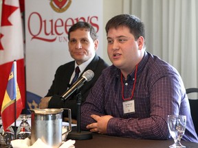 Troy Sherman, municipal affairs commissioner for the Queen's Alma Mater Society,  (right) speaks at the Principal's Community Breakfast at the Holiday Inn Waterfront on Friday as Queen's principal Daniel Woolf look on.
Ian MacAlpine The Whig-Standard