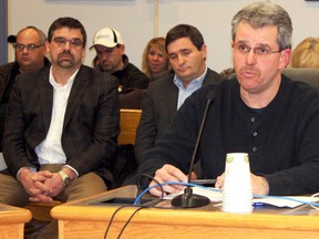 Rick Dubeau, right, spoke at the most recent city council meeting on behalf of the Hollinger Project Community Advisory Committee (HPCAC), raising concerns about the future Hollinger pit site becoming a burden for the taxpayers of Timmins. Goldcorp general manager Marc Lauzier, left, and mine supervisor Paul Miller can be seen listening in the background. Goldcorp and the city will be working with the public over the next few years to develop a Subsequent Land Use Plan to beautify the property and make it an area that residents will be proud of.