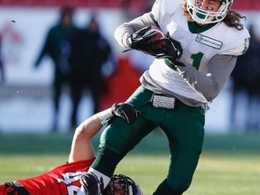Calgary Dinos? Jordan Verdone wraps up  Regina Rams? Jared Janotta from below during the Hardy Cup Canada West championship game in Calgary last Saturday. (Reuters)