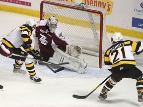 Kingston Frontenacs’ Ryan Kujawinski puts the puck past Peterborough Petes goalie Andrew D’Agostini for Kingston’s first goal of the game during Friday night’s Ontario Hockey League game at the K-Rock Centre. (Michael Lea/The Whig-Standard)