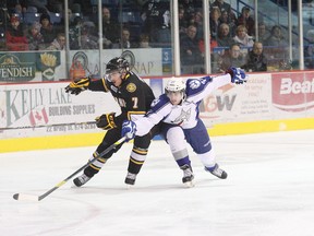 Jack Kuzmyk, left, of the Sarnia Sting, and Mathew Campagna, of the Sudbury Wolves, battle for possession of the puck during OHL action at the Sudbury Community Arena on Friday, November 16, 2012. JOHN LAPPA/THE SUDBURY STAR/QMI AGENCY