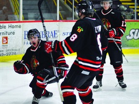 Brockville Braves forward David Ferreira celebrates one of his two goals in Friday night's win over Pembroke with teammates Zach Todd(8) and Cory Wilson. STEVE PETTIBONE/The Recorder and Times