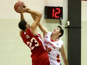 Canadore Panthers Kyle Romaniuk (22) gets called for a foul during the fourth quarter against Benn Ibrahim (23) of the Redeemer Royals during Redeemer's 84-79 win at the Education Centre Gymnasium, Saturday (Ken Pagan, The Nugget)