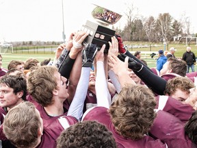 The Frontenac Falcons celebrate their win over the St. Peter Knights during a playdown for the National Capital Bowl at Beckwith Park outside Ottawa on Saturday, Nov. 17.