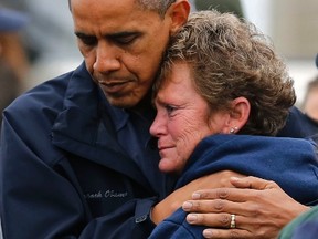 U.S. President Barack Obama comforts Donna Vanzant, whose New Jersey marina was wiped out by Hurricane Sandy.