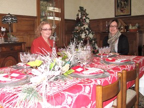 ELLWOOD SHREVE  ellwood.shreve@sunmedia.ca

Nancy Underwood, left, of Bothwell, and Rhonda McLean, of Thamesville, were among the approximately 600 people who took part in the IODE Capt. Garnet Brackin 2012 Christmas House Tour over the weekend. They are pictured here, Sunday, in the festively decorated dining room in the home of the late mayor Garnet Newkirk, located on Longwoods Road.