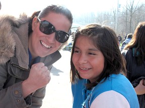 ELLWOOD SHREVE  ellwood.shreve@sunmedia.ca

Canadian Olympic boxer Mary Spencer signed autographs and shared some inspirational words with the Delaware Nation at Moraviantown on Sunday during the annual Walk Towards Wellness event. Here, she is pictured with Jaylee Stonefish, 10, one of many youngsters who received an autographed photo and mini boxing gloves from Spencer.