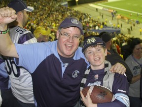 Argos fans Bill Howe and his son, Liam, who were in Montreal for Sunday's game. (JOE WARMINGTON, Toronto Sun)
