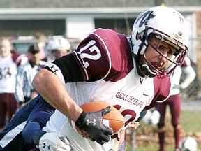 Tartans tight end Troy Babcock makes a catch during the SWOSSAA 'A-AA' senior football final against the Cardinal Carter Cougars on Saturday in Wallaceburg. (DAVID GOUGH/QMI Agency)