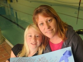 Elizabeth Pratt, 9, and her mom Cindy show off a poster of brother Graham, who passed away suddenly last month. Onaping residents will be holding the Graham Pratt Memorial Swim-A-Thon to help raise funds for the CTV Lions Children's Christmas Telethon.