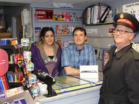 Taking part in launching the holiday tradition were store manager Nadia Hossein-Khani, left, store owner Ken Joanisse and Salvation Army representative Craig Wilson. Timmins Times LOCAL NEWS photo by Len Gillis.