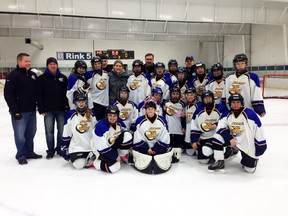 The Fort McMurray Bantam female Junior Oil Barons pose with Hayley Wickenheiser after winning the championship in the Bantam Tier II Division of the Wickenheiser International Women’s Hockey Festival in Burnaby, B.C., on Sunday. SUPPLIED PHOTO